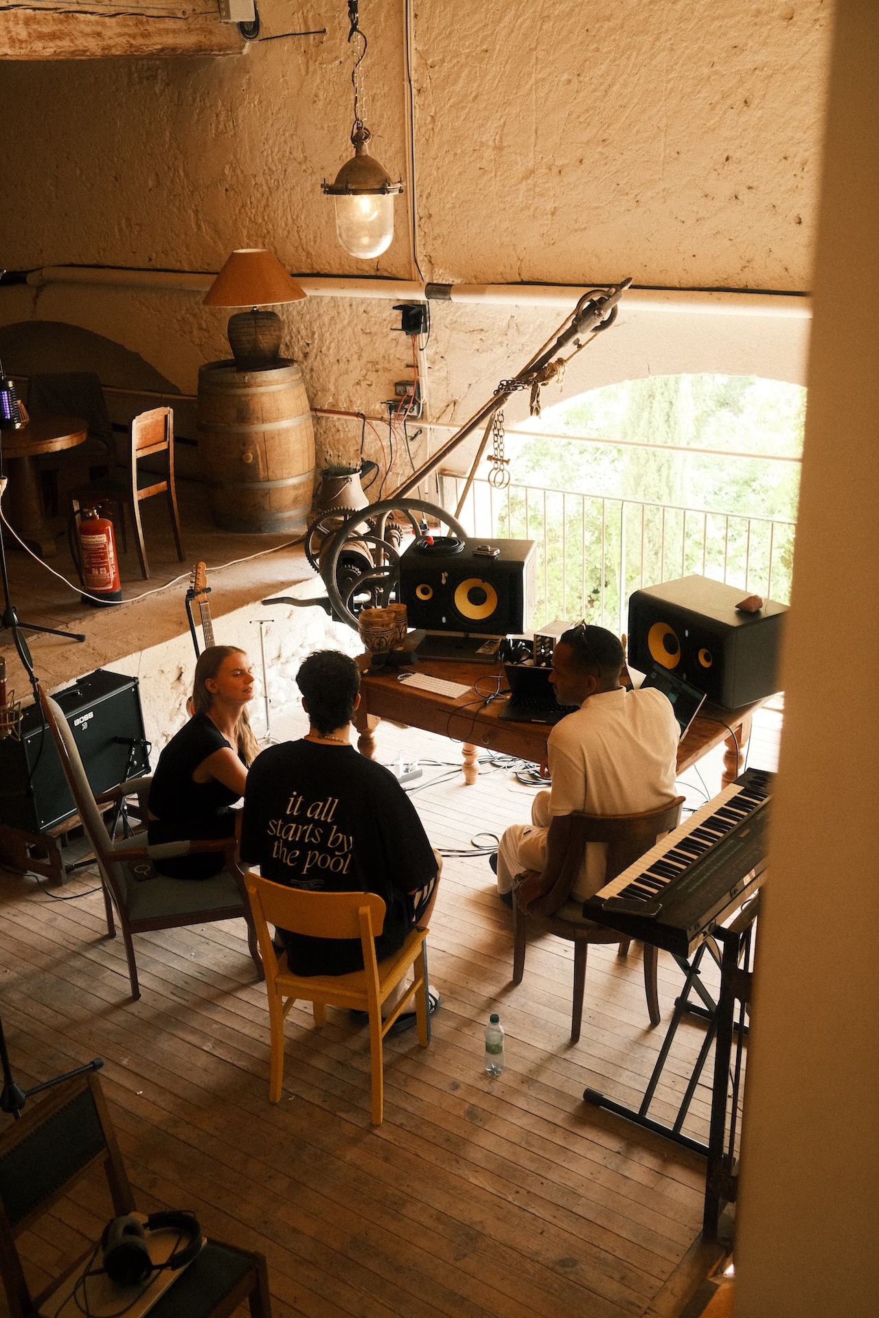 Participants producing music together at a keyboard in the studio
